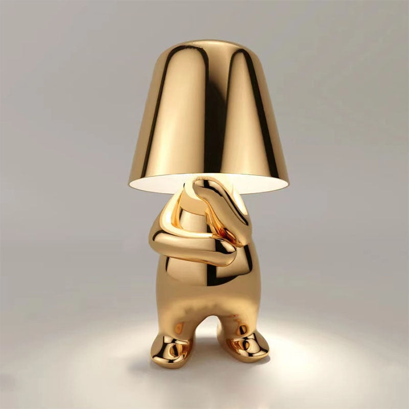 Metallic table light with reflective artistic form