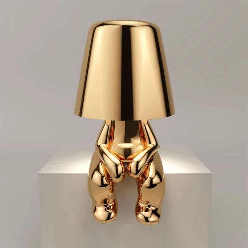 Metallic table light with reflective artistic form