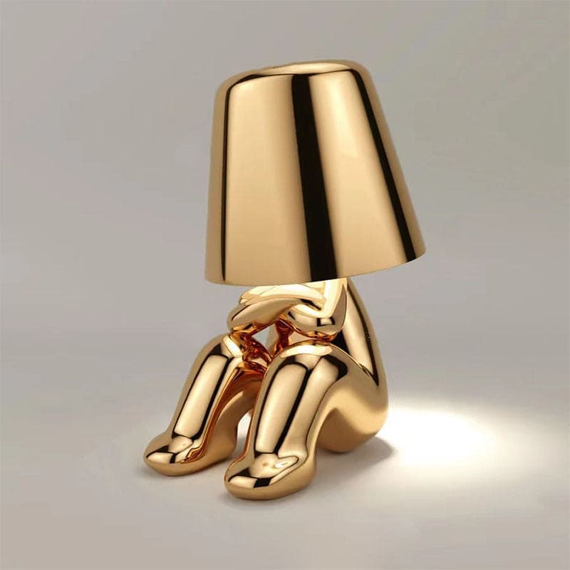 Metallic table light with reflective artistic form
