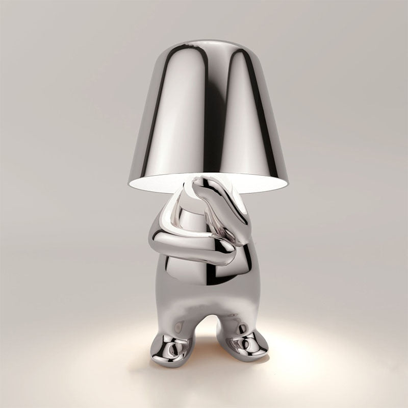 Metallic table light with reflective artistic form