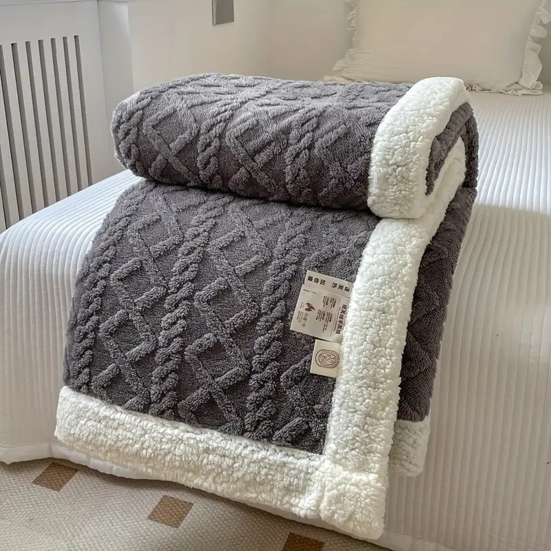 Reversible textured blanket with geometric pattern