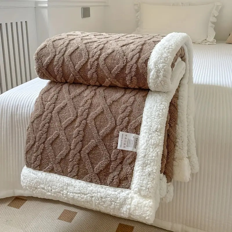 Reversible textured blanket with geometric pattern