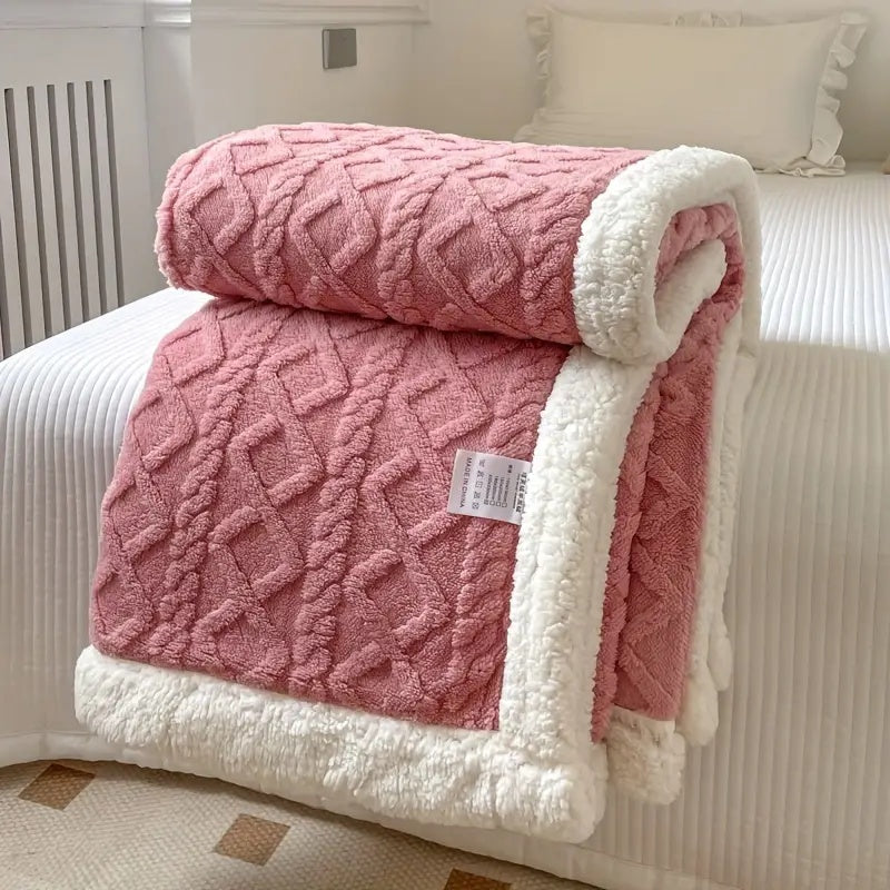 Reversible textured blanket with geometric pattern